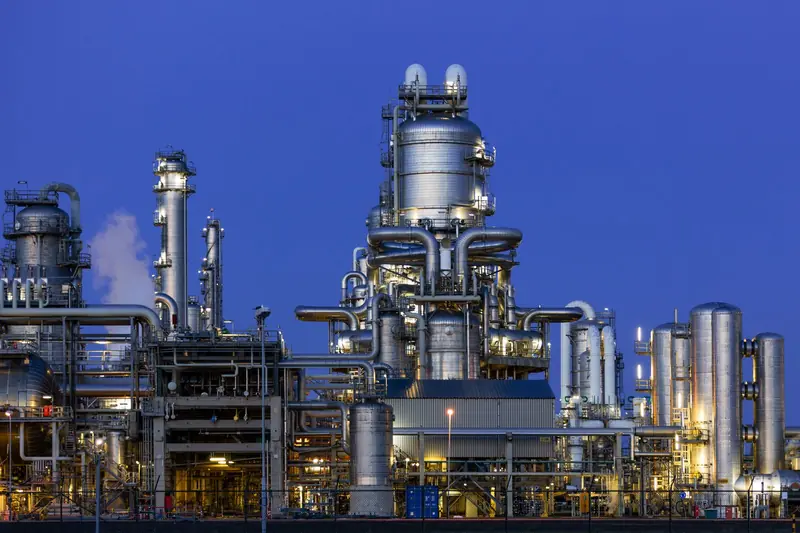 An oil refinery illuminated at twilight
