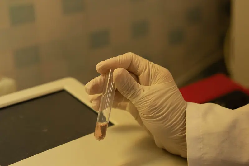 A technician holding a sample tube in a laboratory